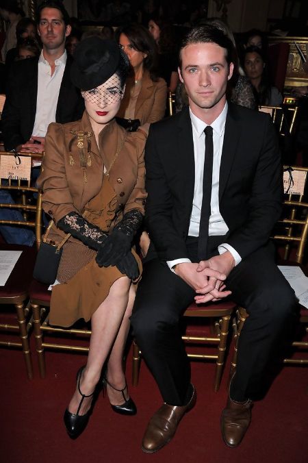 Louis-Mare De Castelbajac and model Dita Von Teese in a formal event pose for a picture.